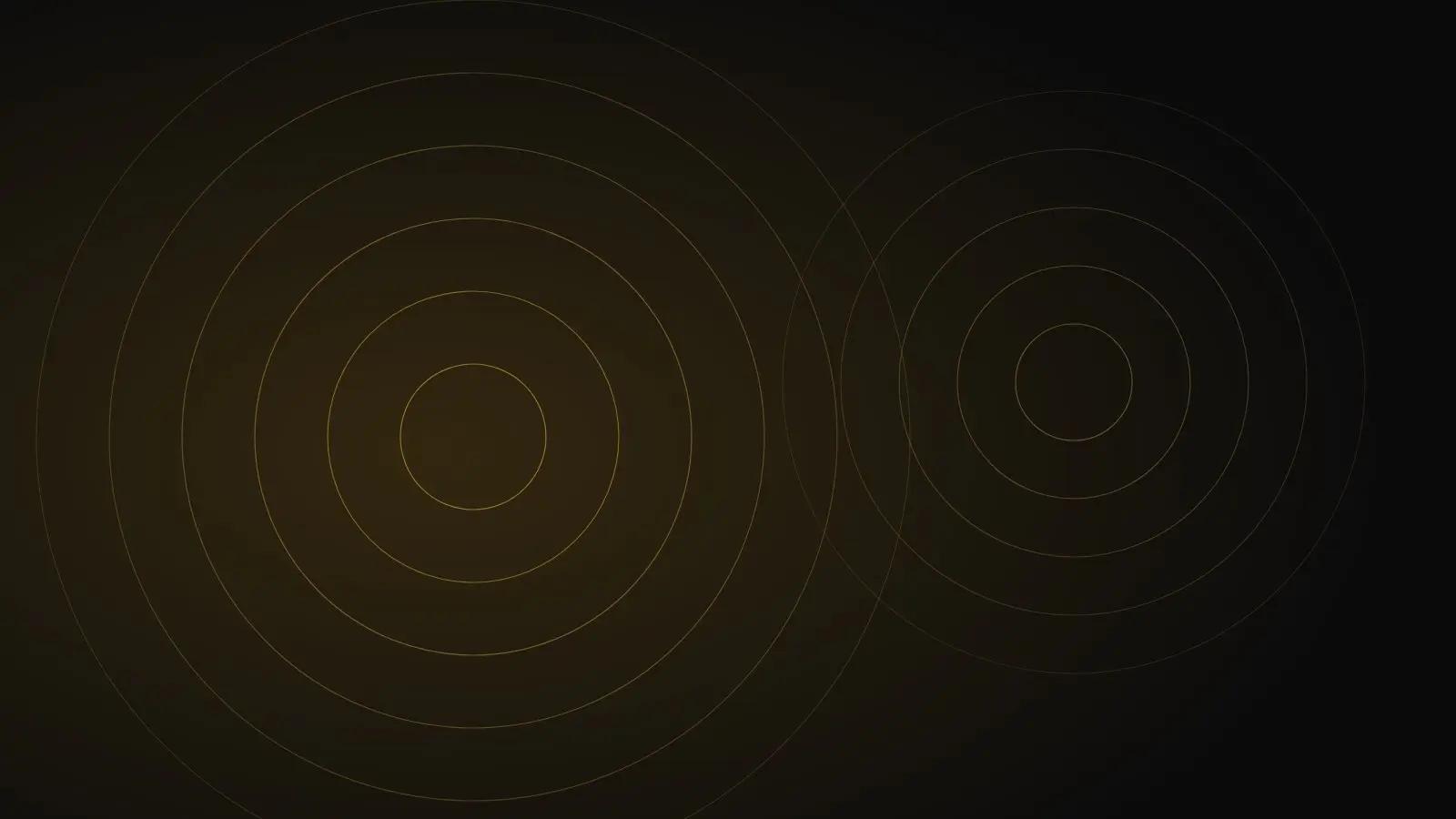 Overlapping gold rings on a dark background